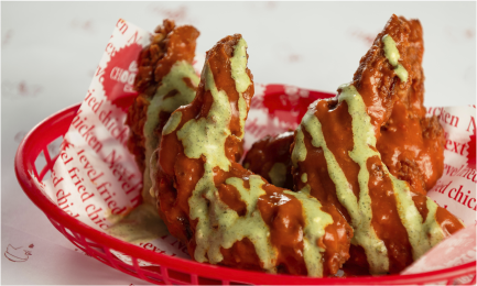 Crispy fried chicken tenders drizzled with green sauce from Chooks Fried Chicken, Edinburgh
