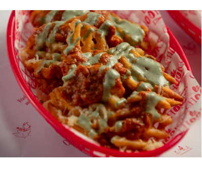 Waffle fries topped with crispy fried chicken and sauce from Chooks Fried Chicken, Edinburgh